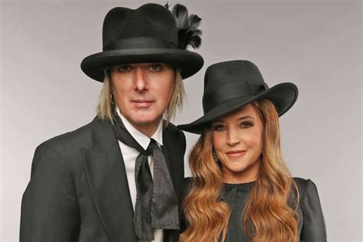 Michael Lockwood and his twin girls photographed outdoors