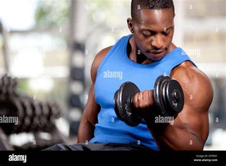 barbell curl muscular young man lifting weights outside barbell curl