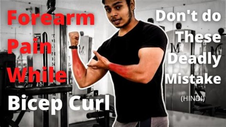 My forearms hurt during biceps curls. How can I stop the pain while still working on my arms?