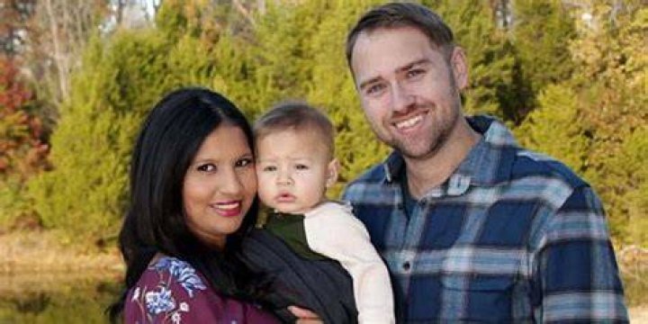 Paul and Karine from TCL's 90 Day Fianc&eacute; series smiling and standing on street
