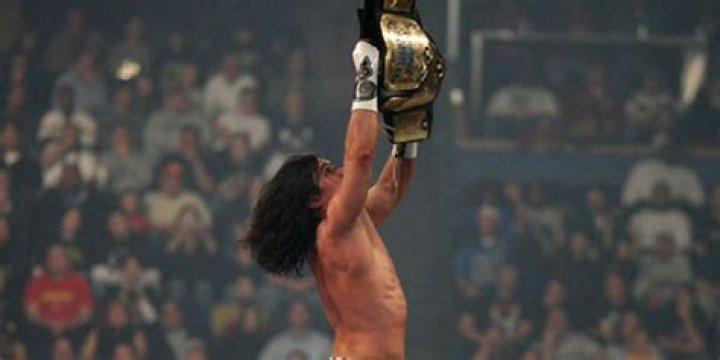 Paul London unhooking the title at Armageddon 2006