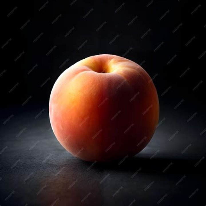 Flat peach with green leaves On a black wooden background. Top view. Free space for your text. peach on a black background