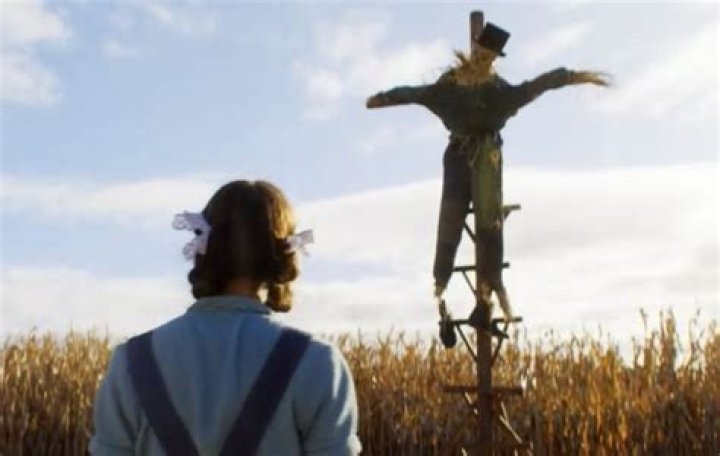 Pearl climbing up a scarecrow.