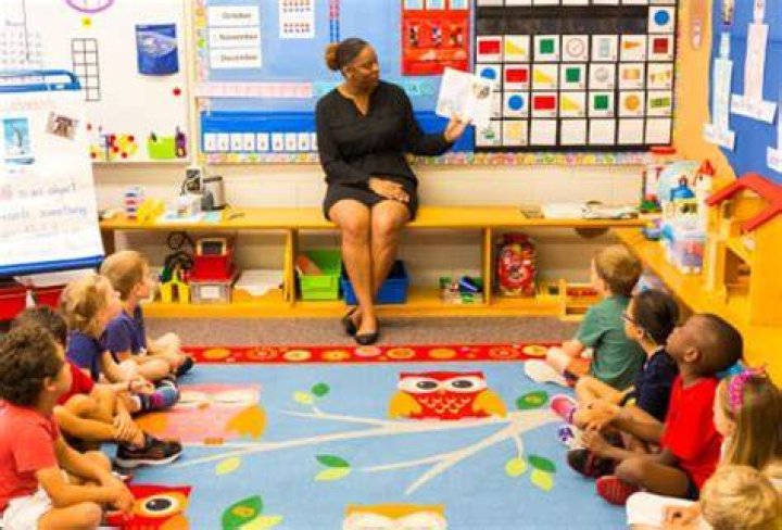preschool kids with their classroom pet guinea pig