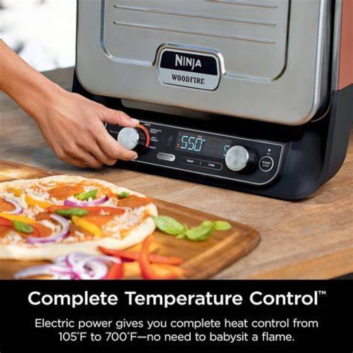 Putting Pizza into Ninja Woodfire Outdoor Oven