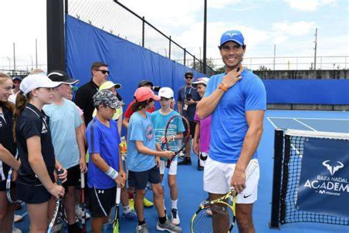 Rafa Nadal (L) greets students of the "Rafa Nadal Academy" in Manacor on October 11 2018 Nadal is considered one of the best tennis players of all time(Photo by JAIME REINA/AFP via Getty Images)