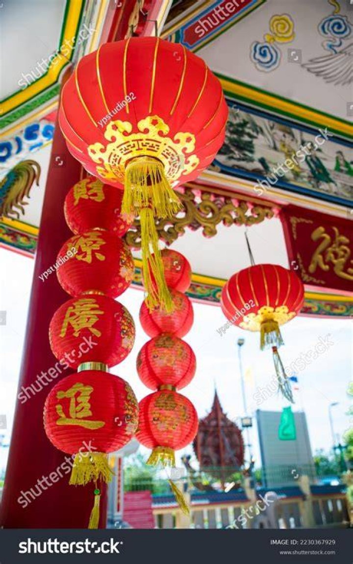 Red chinese lanterns hanging from a balcony