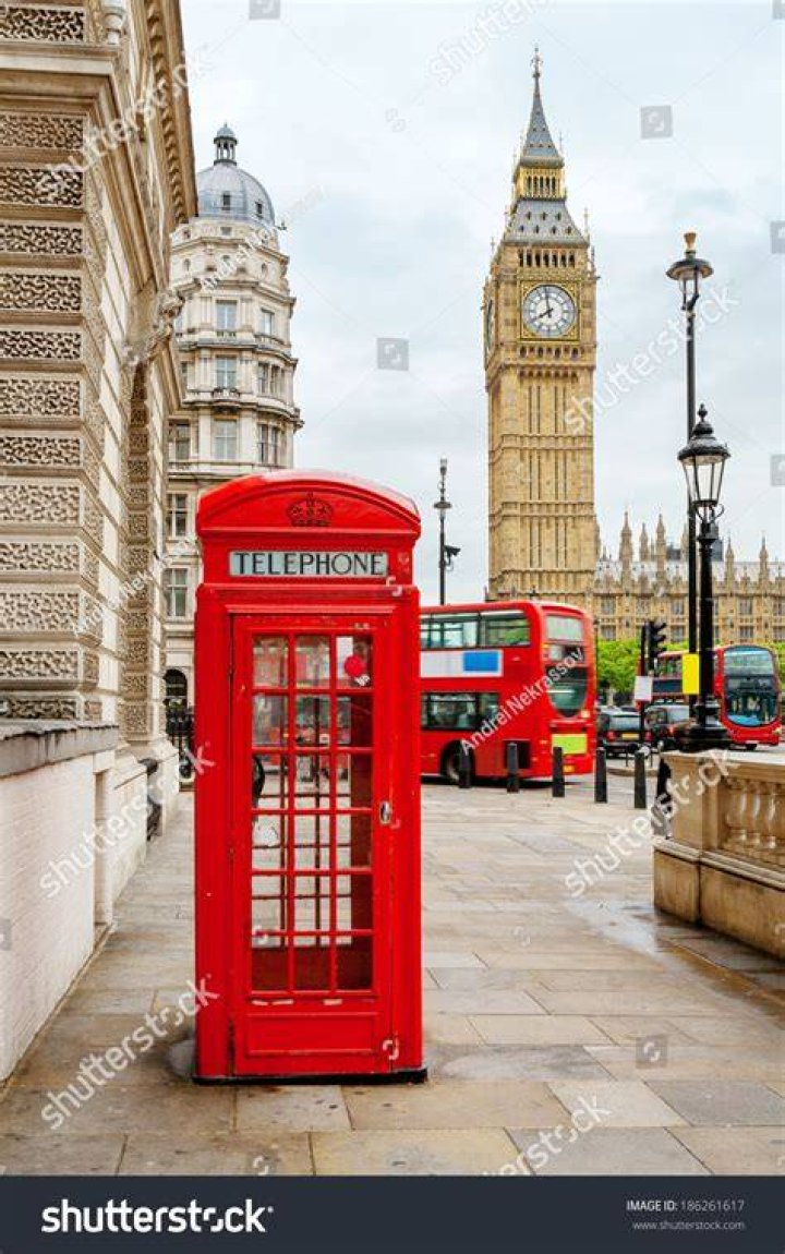  Red phone booth near Big Ben in London, England