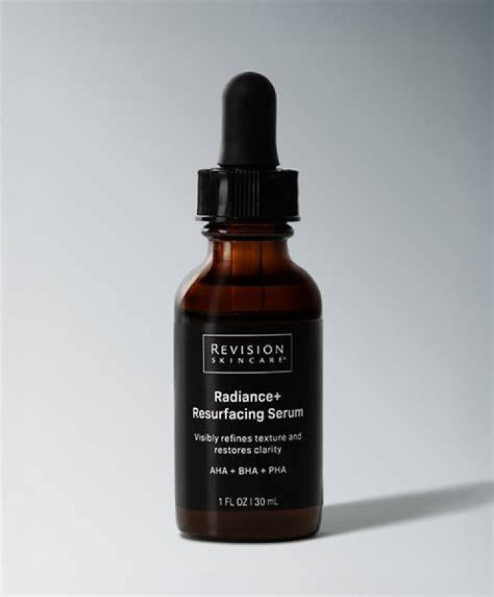 revision skincare neck serum in a black bottle on a white background