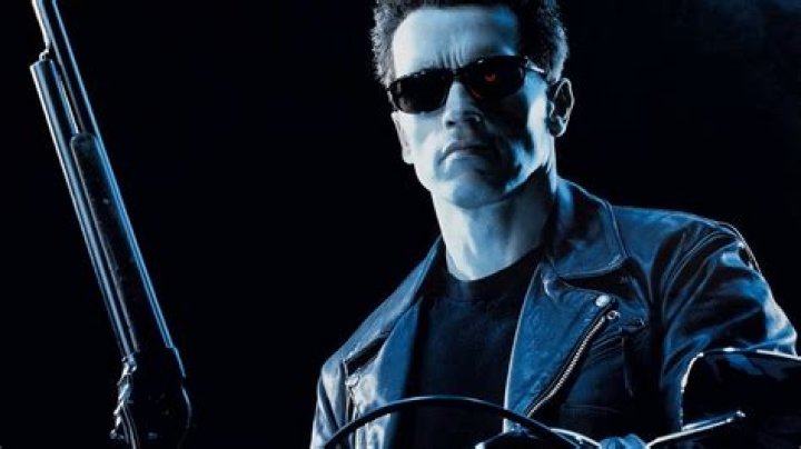 Sarah, John, and the T-800 look worried in a hallway in Terminator 2