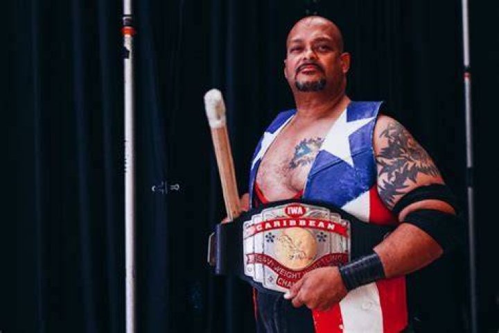 Savio Vega with the Caribbean Heavyweight Championship