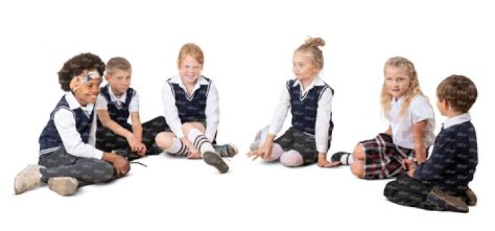 Students sitting in a semi-circle around their instructor outside