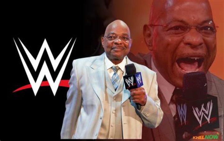 Teddy Long outside the ring with his fellow WWE referee.