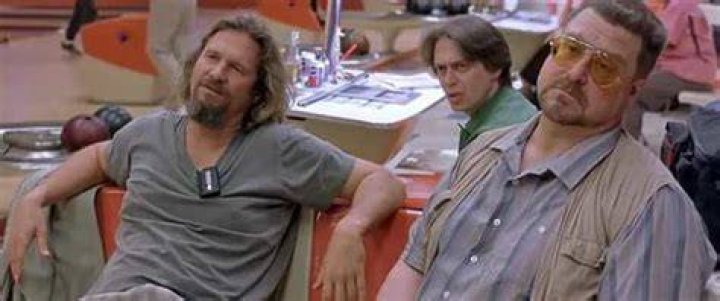 The Dude, Walter, and Donny sitting in a bowling alley in The Big Lebowski