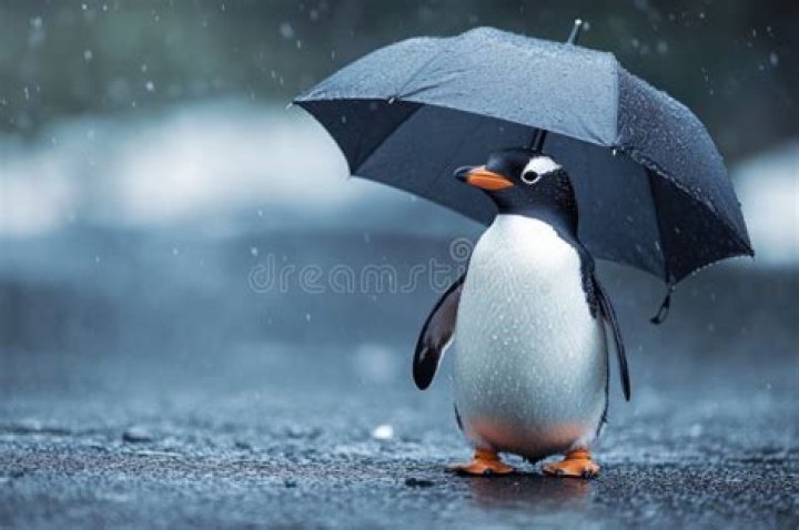 The Penguin holding his umbrella whilst aiming a pistol in Batman comics
