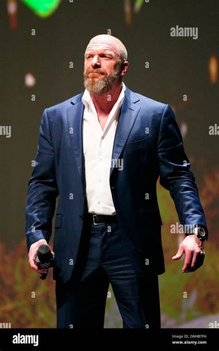 Triple H in a suit cutting a promo