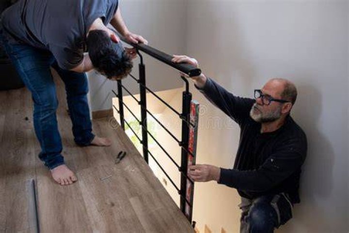 two men working on installing a kitchen