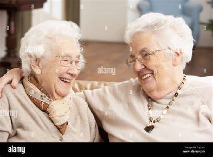 two old age senior friends drinking cofee