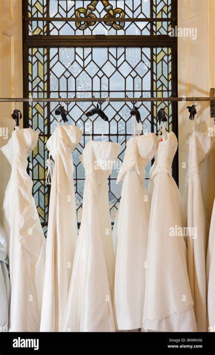 Wedding dresses hanging on clothes rack at store