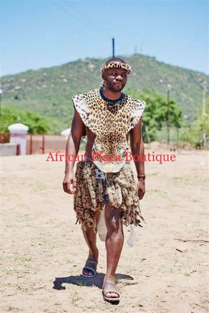 White man in Zulu attire does indlamu