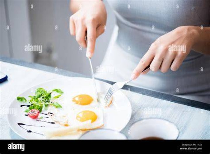 woman eating eggs