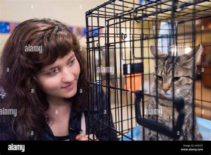 woman smiling by cage adoption