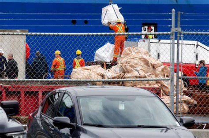 Workers handle debris from the Titan submersible at the Canadian Coast Guard pier in St. John's. Photo / Paul Daly, The Canadian Press via AP